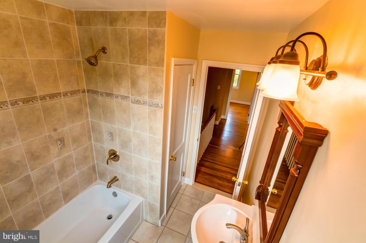 1546 Northbourne Road Baltimore, MD 21239 - Photo 9 of 18 a bathroom with a sink and a tub