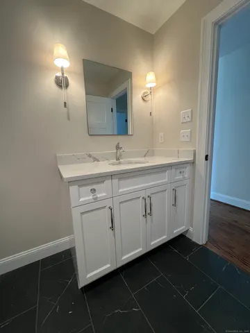 a bathroom with a double vanity sink and a mirror