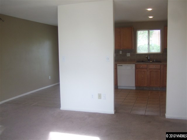 10012 Albite Street Reno, NV 89506 - Photo 3 of 9 an empty room with windows and cabinet