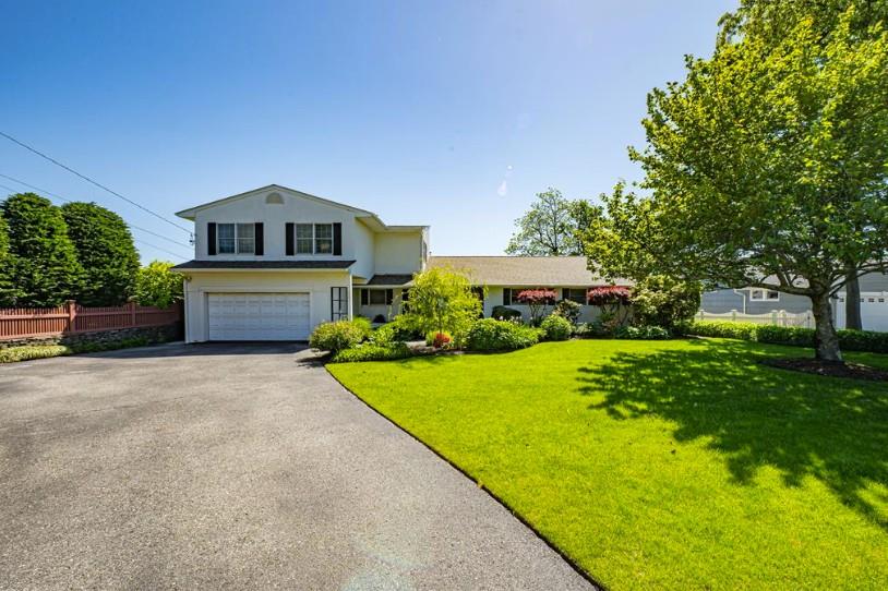 Traditional-style home featuring asphalt driveway and an attached garage