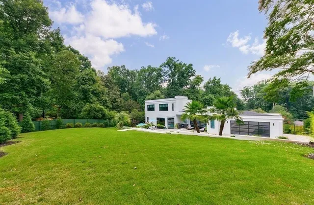 a house view with a sitting space and garden