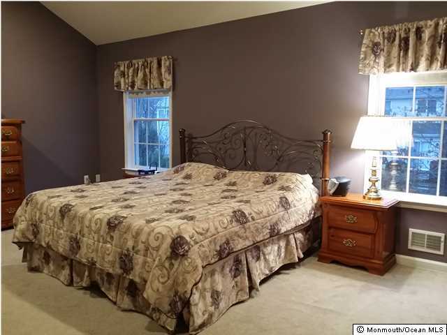 159 Brigantine Road Manahawkin, NJ 08050 - Photo 13 of 23 a bed sitting in a bedroom next to a window