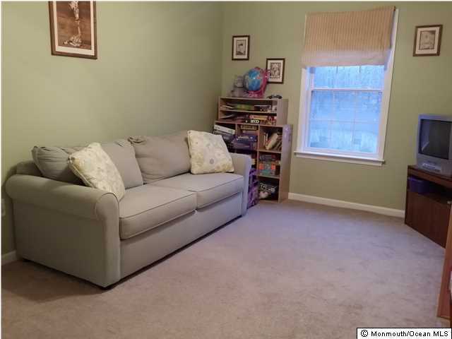 159 Brigantine Road Manahawkin, NJ 08050 - Photo 17 of 23 a living room with furniture and a flat screen tv
