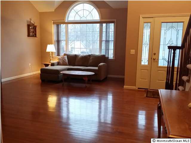 159 Brigantine Road Manahawkin, NJ 08050 - Photo 2 of 23 a living room with furniture wooden floor and a large window