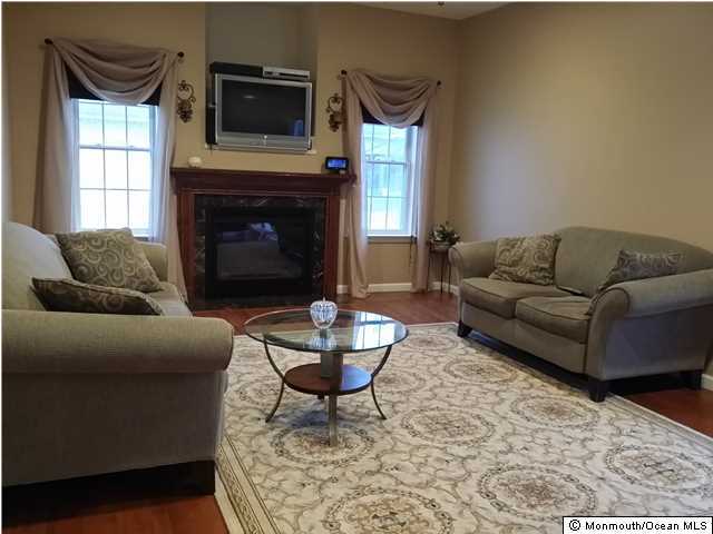 159 Brigantine Road Manahawkin, NJ 08050 - Photo 6 of 23 a living room with furniture and a fireplace