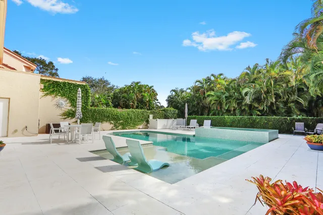 a view of backyard with seating area and green space