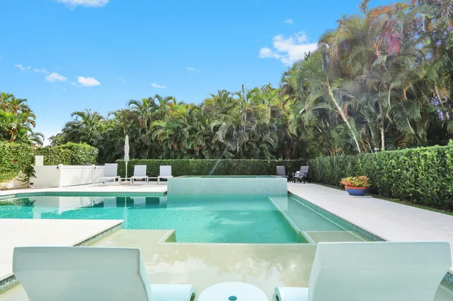 a front view of a house with garden and porch