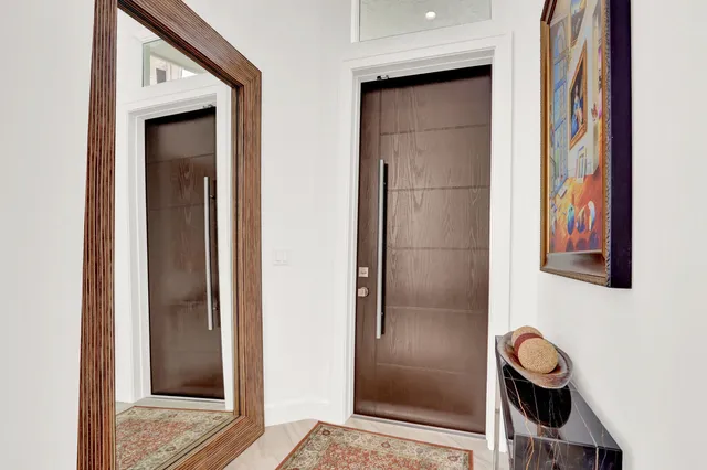 a bathroom with a granite countertop bathtub shower and mirror