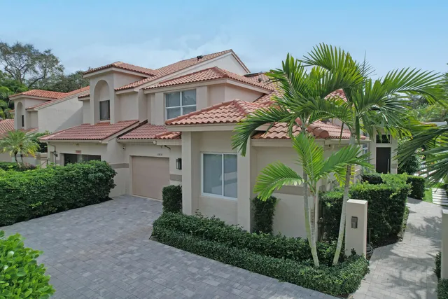 an aerial view of multiple houses with a yard