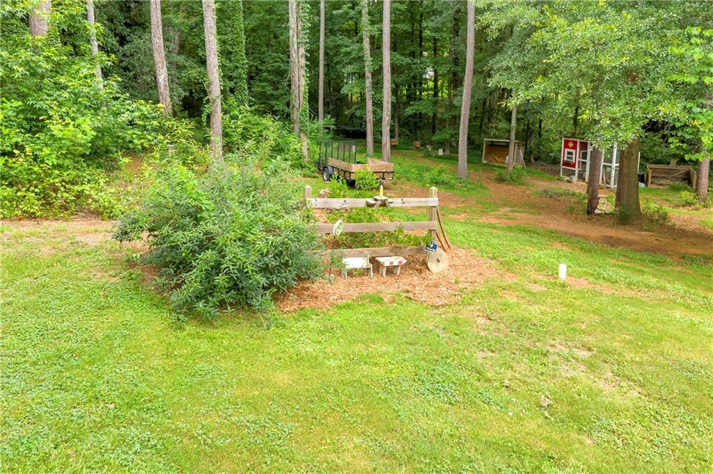 587-j B J B Owens Road Bethlehem, GA 30620 - Photo 9 of 99 a backyard of a house with lots of green space and garden view