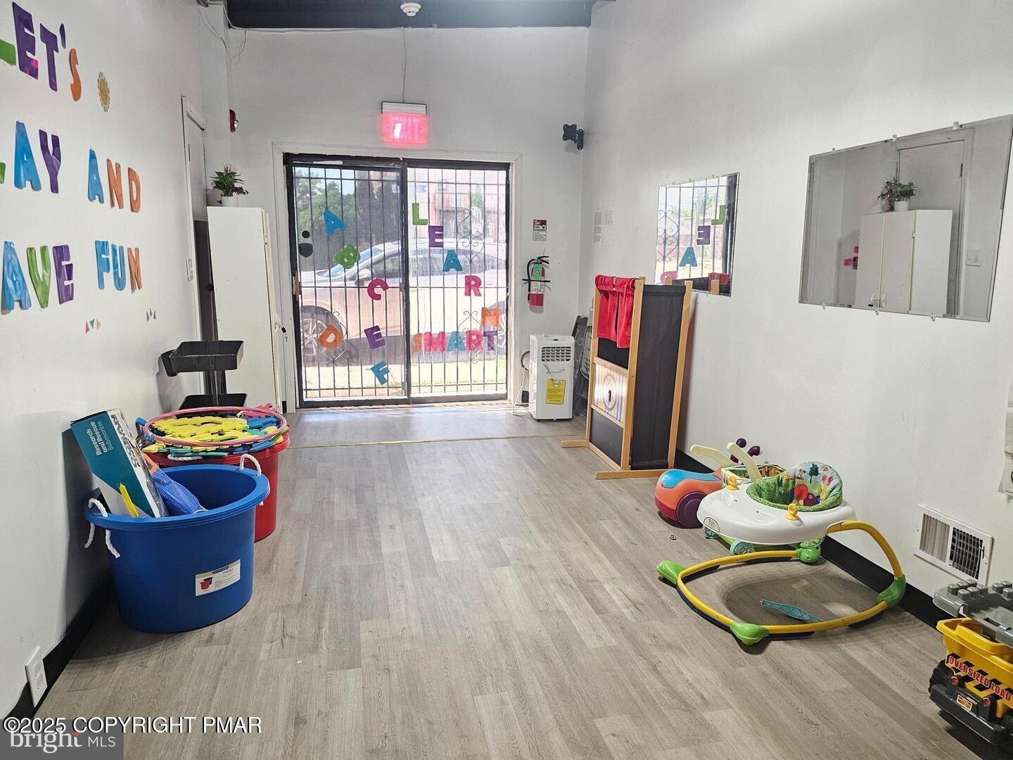 619 Fulton Street Chester, PA 19013 - Photo 5 of 8 a living room with furniture and a wooden floor
