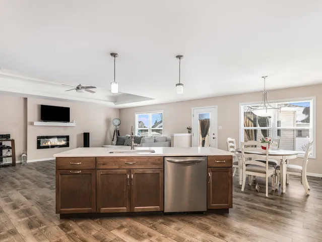 a large white kitchen with a large island in the center