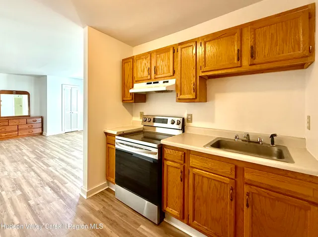 a kitchen with stainless steel appliances granite countertop a sink stove and cabinets