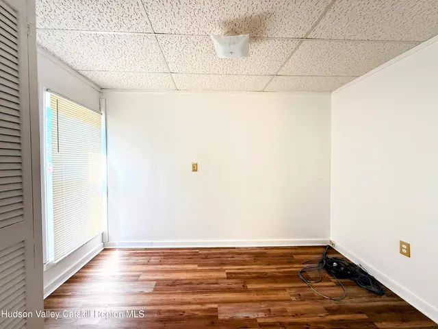 a view of a room with wooden floor