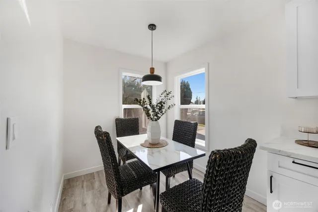 a dining room with furniture and wooden floor