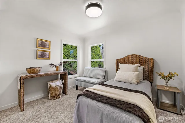 a bedroom with a bed and a potted plant