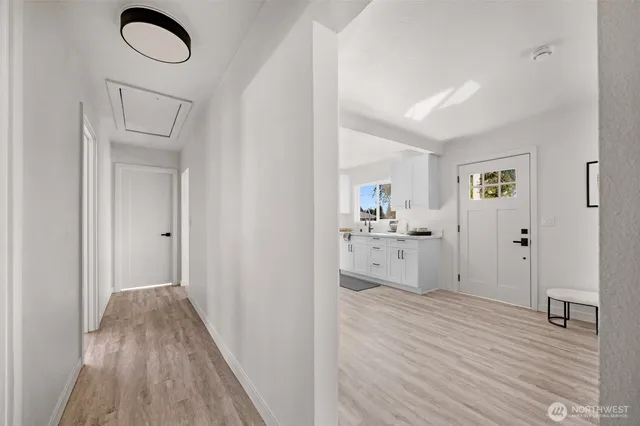 a view of a kitchen from the hallway with closet