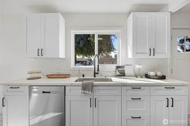 a kitchen with a sink stove and cabinets