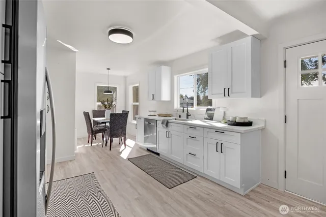 a kitchen with a sink cabinets and dining table chair
