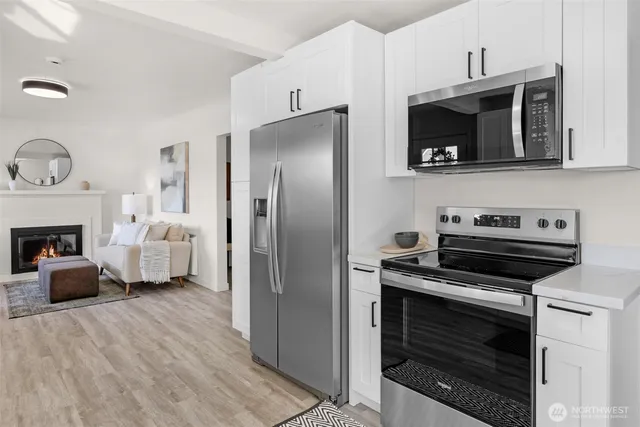 a kitchen with stainless steel appliances a stove a microwave and a refrigerator