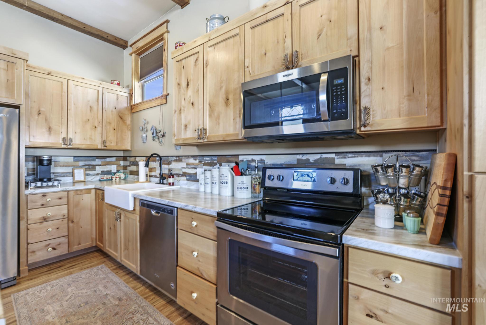 203 North Brush Road Fairfield, ID 83327 - Photo 46 of 50 Kitchen with light brown cabinets, stainless steel appliances, and light wood finished floors