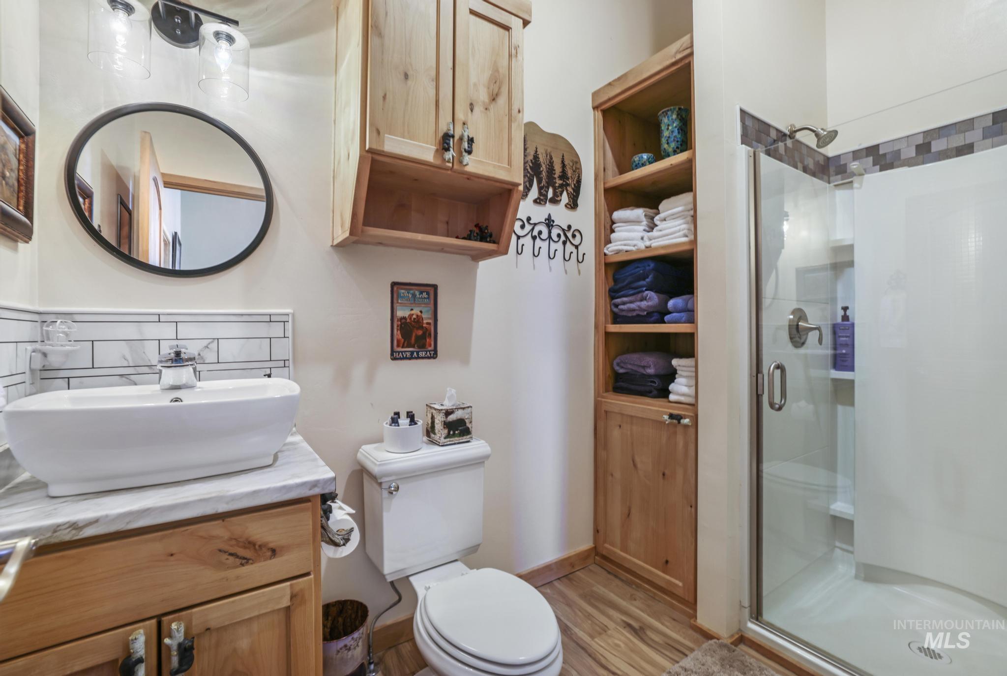 203 North Brush Road Fairfield, ID 83327 - Photo 48 of 50 Full bath with a shower stall, vanity, and wood finished floors