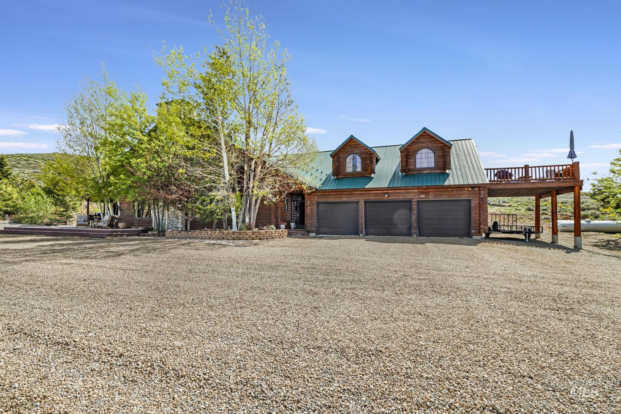203 North Brush Road Fairfield, ID 83327 - Photo 5 of 50 Rustic home featuring driveway, a metal roof, and an attached garage
