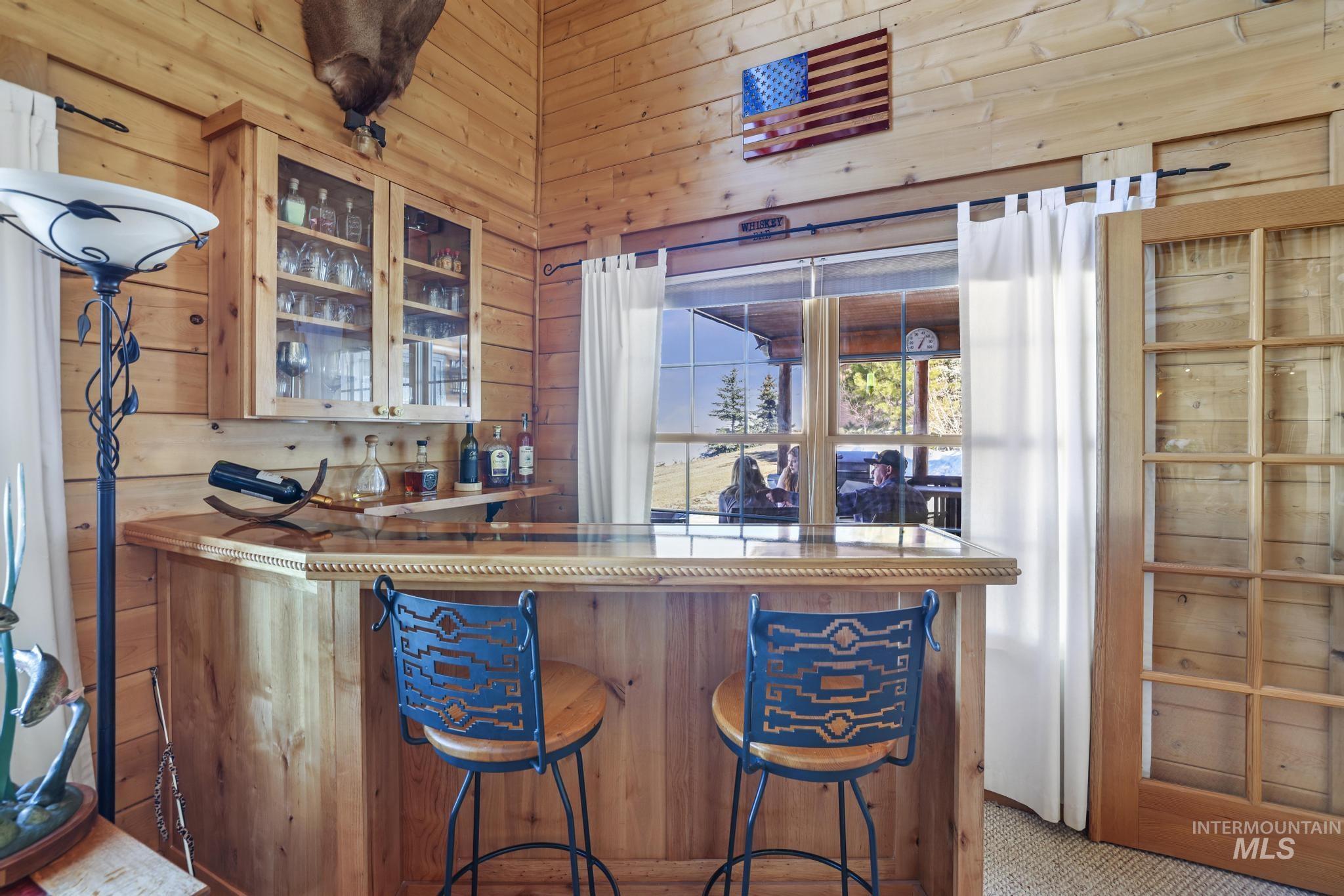 203 North Brush Road Fairfield, ID 83327 - Photo 9 of 50 Indoor dry bar featuring wood walls