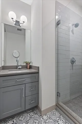a bathroom with a sink a vanity and shower