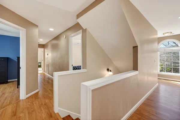 a spacious bedroom with a bed and a chandelier