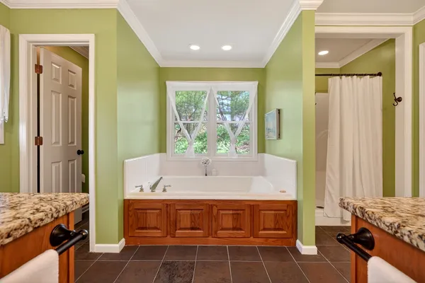 a spacious bathroom with a double vanity sink and a mirror