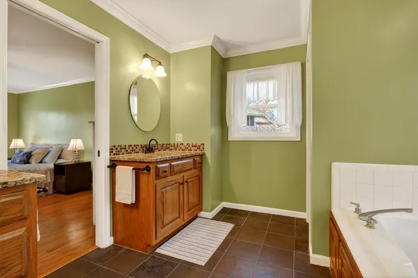 a bedroom with two beds and a chandelier