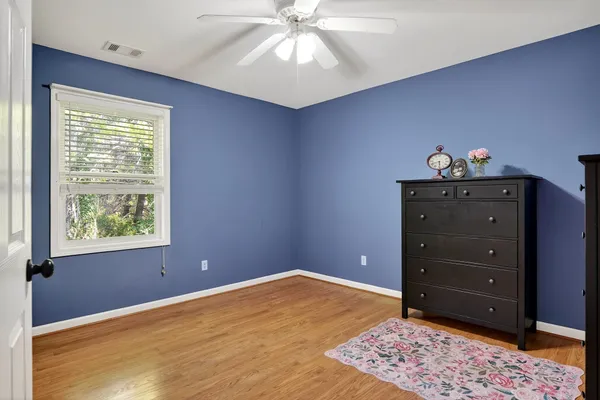 a view of a livingroom with a large window wooden floor and front door