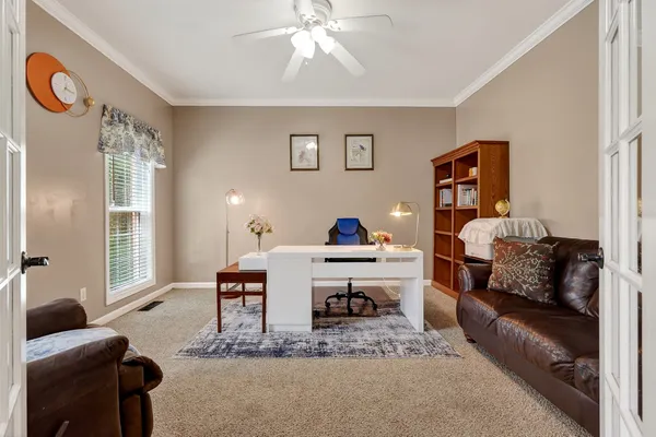 a living room with furniture and a fireplace