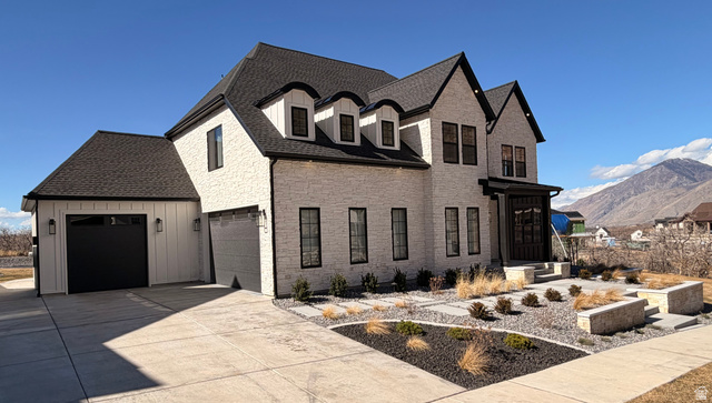 3626 Riverstone Road Mapleton, UT 84664 - Photo 52 of 58 View of front of house featuring driveway, a mountain view, and roof with shingles
