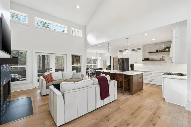 a kitchen with a table chairs refrigerator and microwave