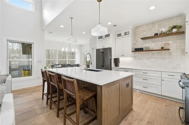 a kitchen with a stove a sink a microwave oven and a refrigerator