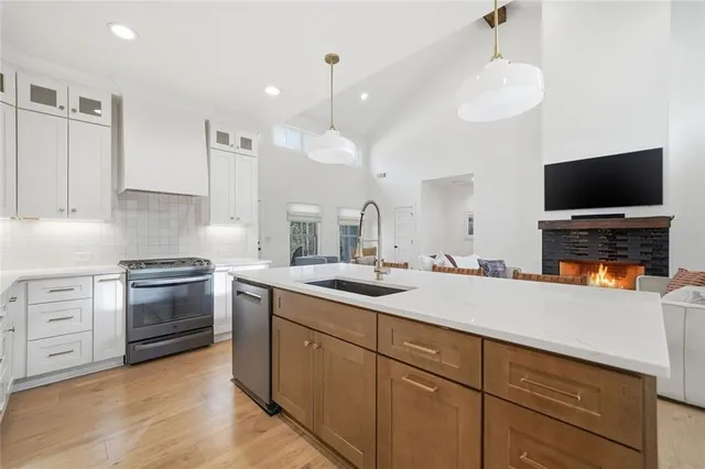 a kitchen with a refrigerator a sink and cabinets