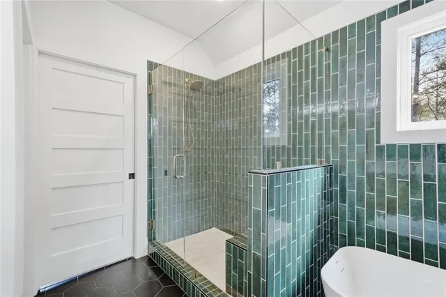 a view of a hallway with windows and stairs