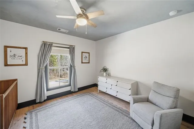 a view of a livingroom with furniture and staircase