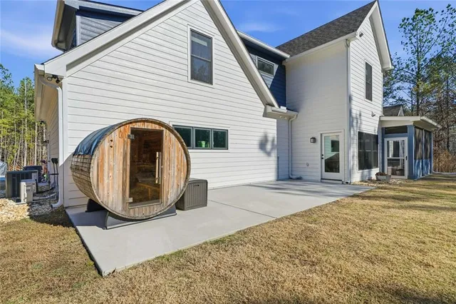 a aerial view of a house with a yard and lake view