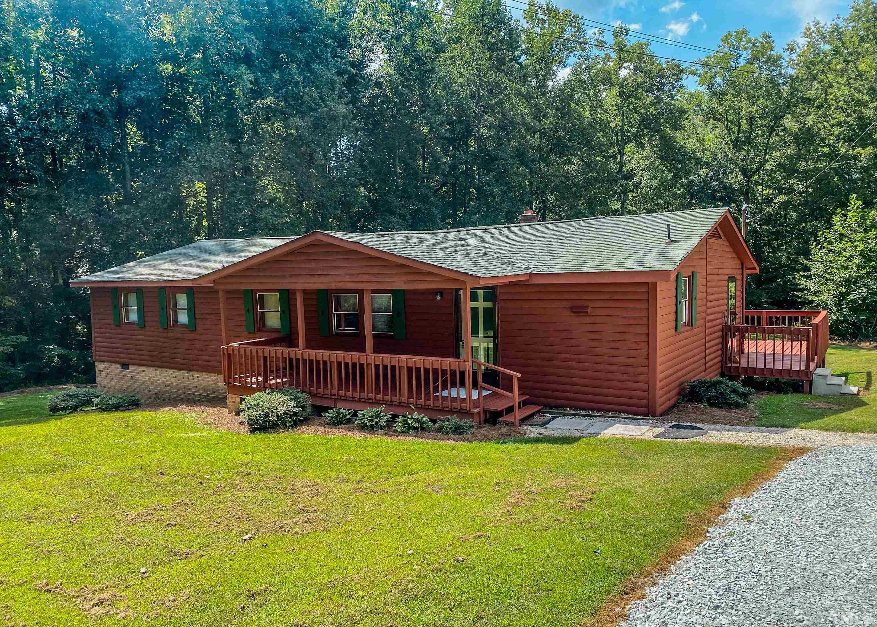 358 Gravitte Road Roxboro, NC 27573 - Photo 1 of 35 a front view of a house with garden