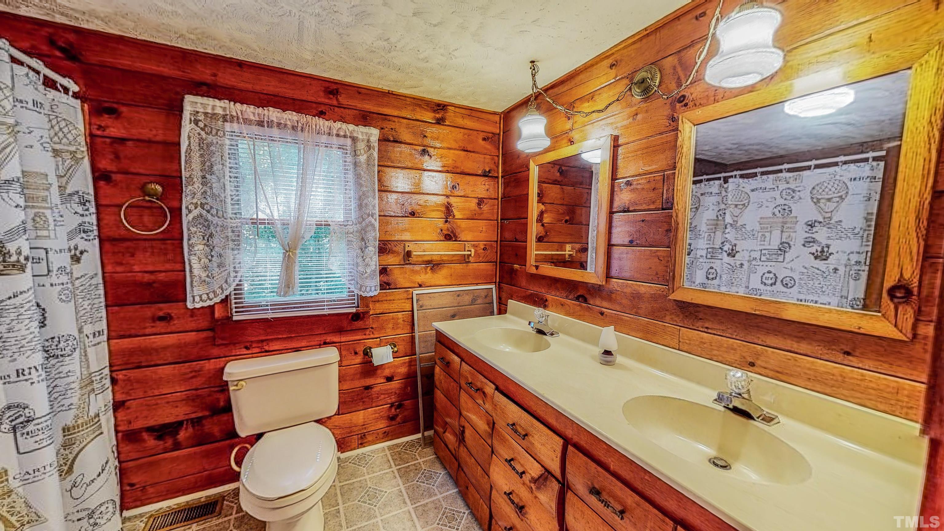 358 Gravitte Road Roxboro, NC 27573 - Photo 15 of 35 a bathroom with a sink a toilet and shower
