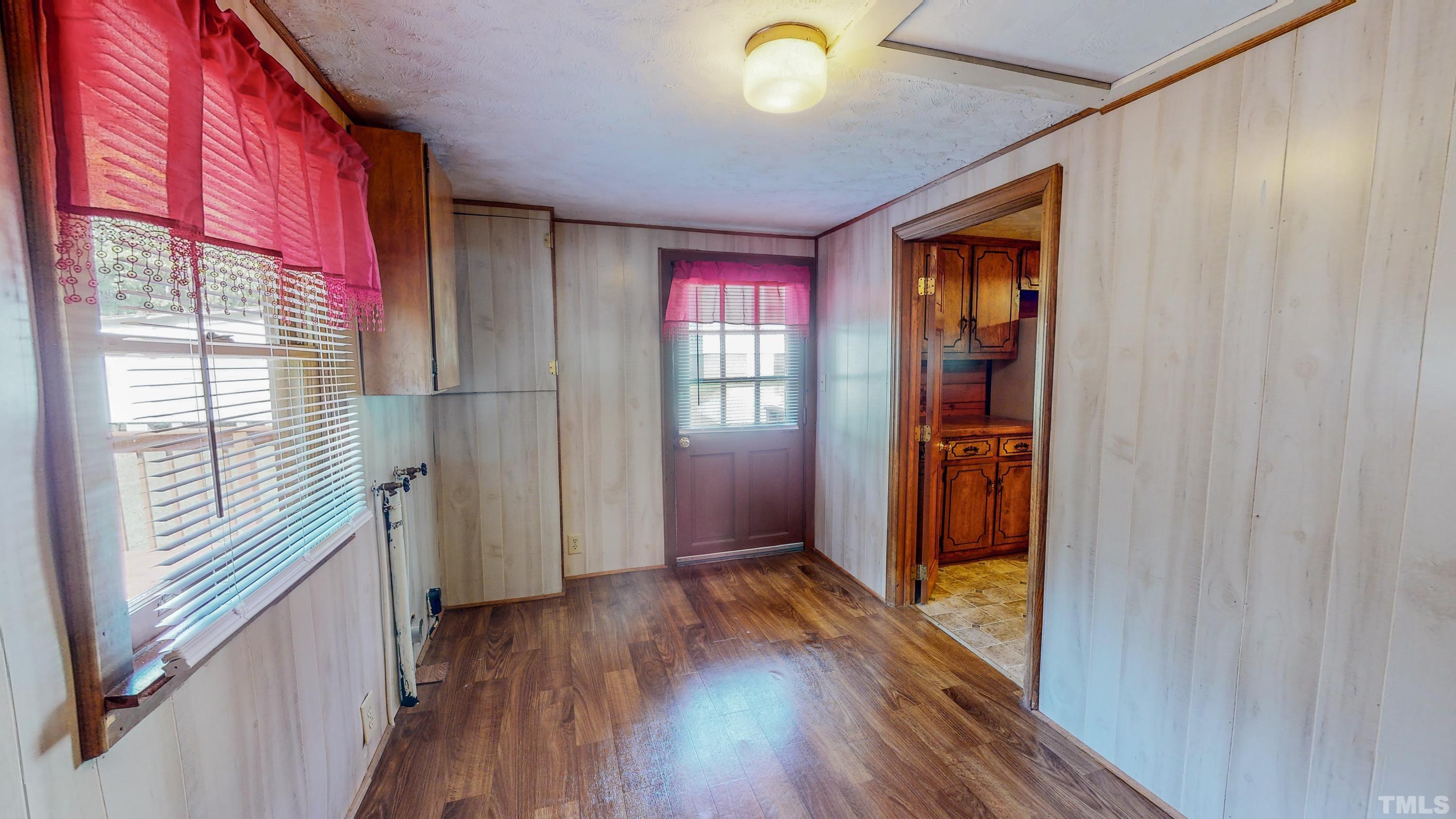 358 Gravitte Road Roxboro, NC 27573 - Photo 32 of 35 a view of hallway with a large window and wooden floor