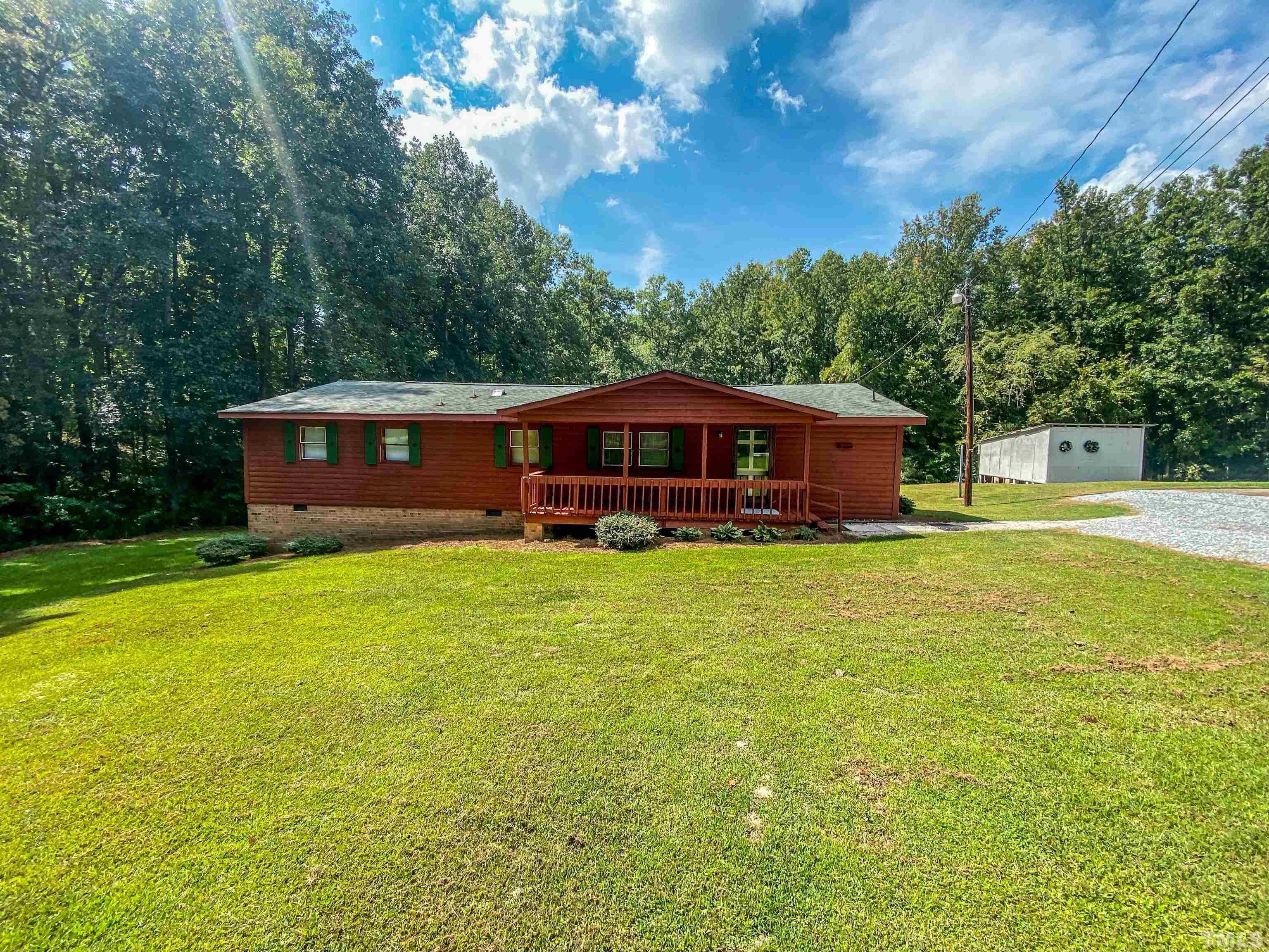 358 Gravitte Road Roxboro, NC 27573 - Photo 34 of 35 a front view of a house with a garden
