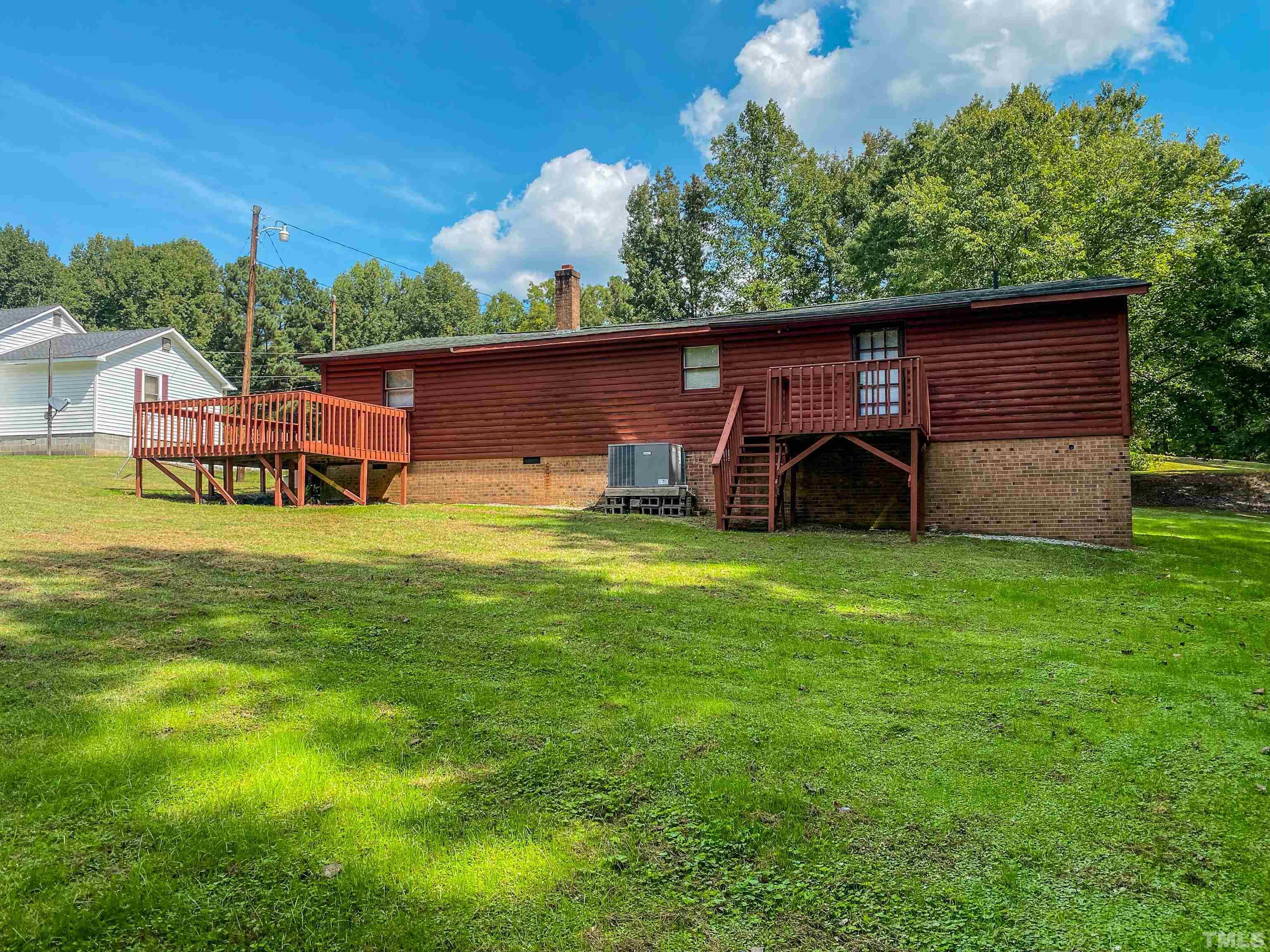 358 Gravitte Road Roxboro, NC 27573 - Photo 35 of 35 a view of a backyard with table and chairs and a large tree