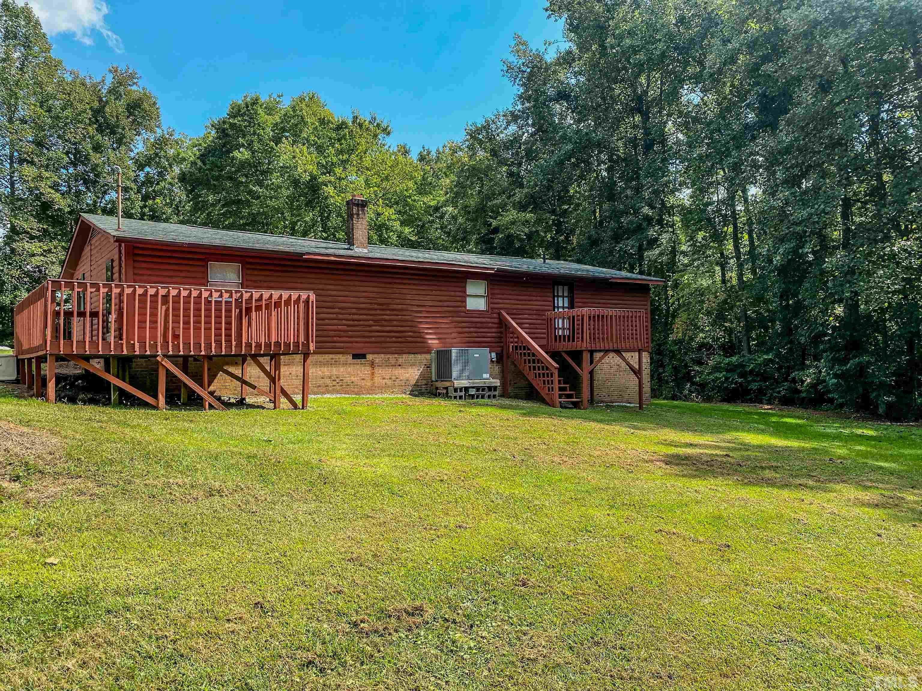 358 Gravitte Road Roxboro, NC 27573 - Photo 6 of 35 a view of a backyard with a garden