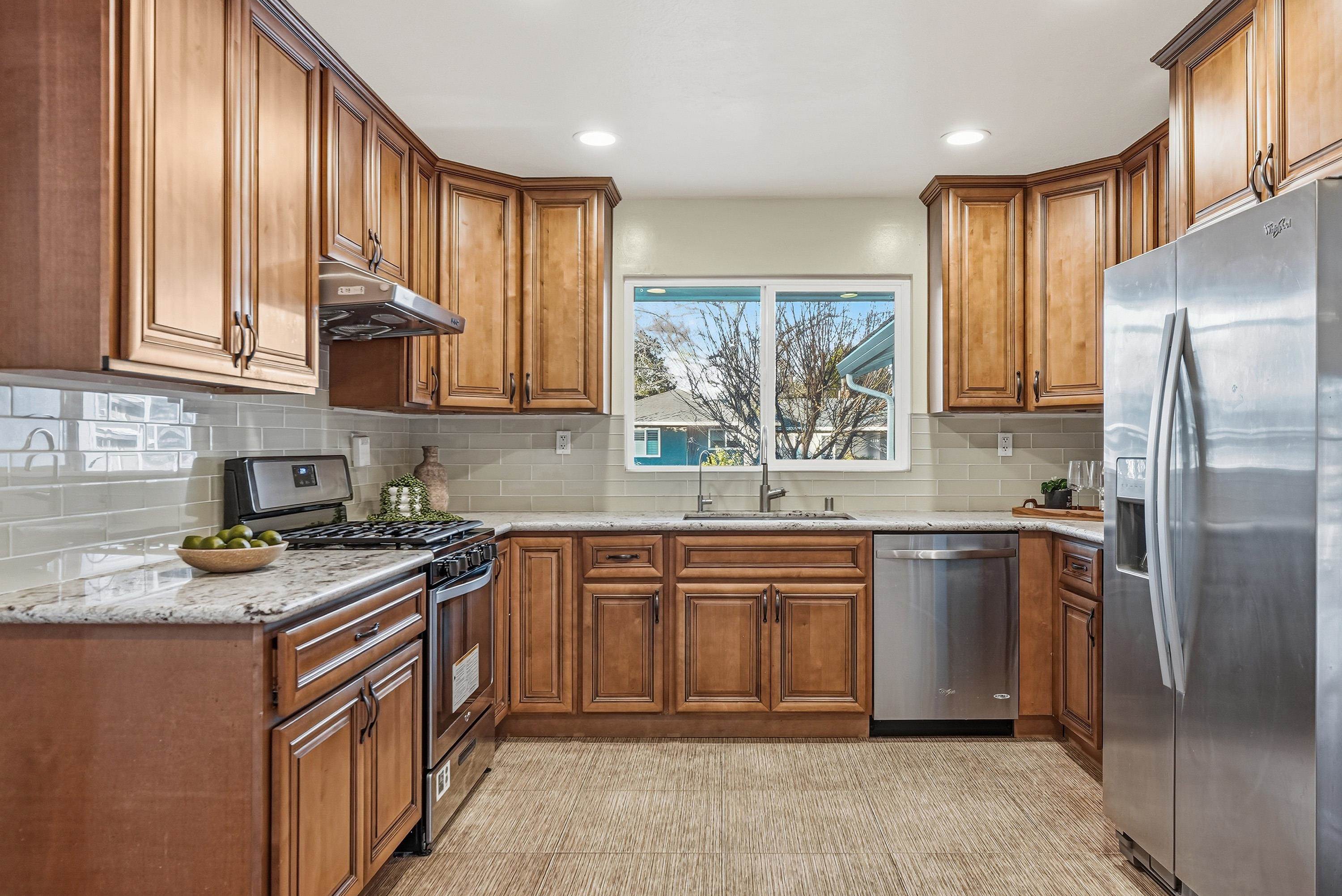 4214 Wells Street Pleasanton, CA 94566 - Photo 13 of 38 a kitchen with stainless steel appliances granite countertop a stove a sink dishwasher and a refrigerator