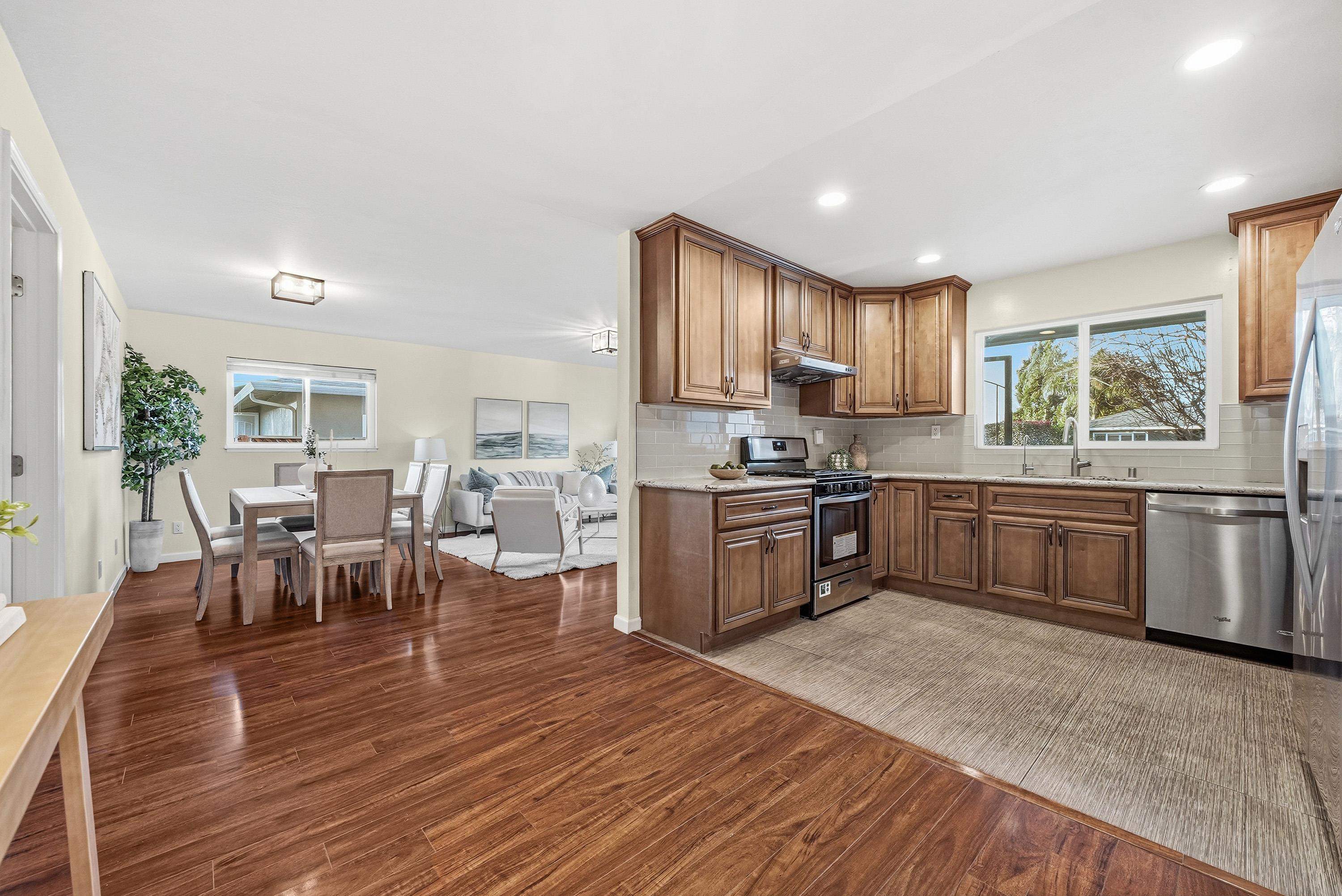 4214 Wells Street Pleasanton, CA 94566 - Photo 14 of 38 a kitchen with a table chairs sink and cabinets