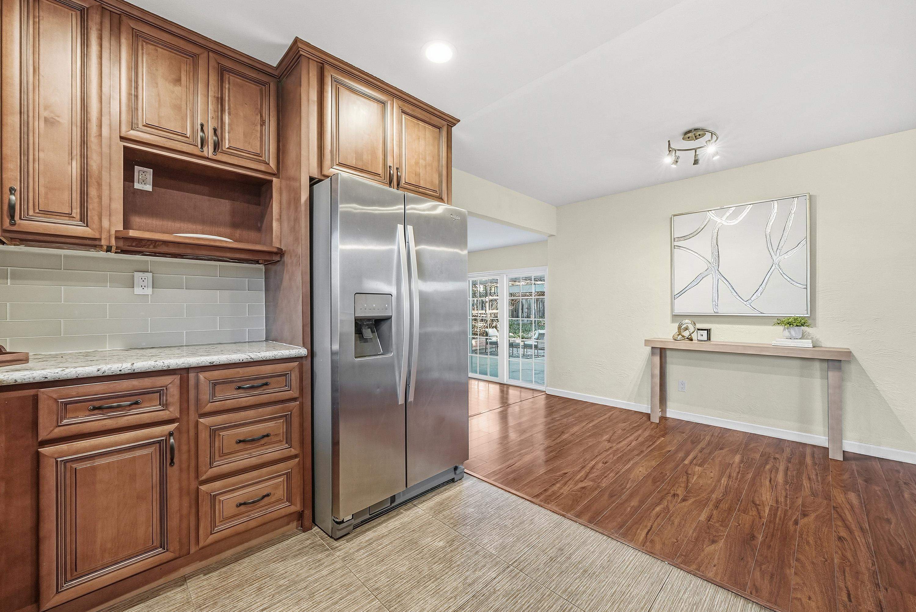 4214 Wells Street Pleasanton, CA 94566 - Photo 16 of 38 view of kitchen with granite countertop cabinets and refrigerator
